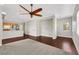 Bright living room with dark hardwood floors and a view of the kitchen at 10120 Cedar Key Ave # 201, Las Vegas, NV 89129