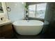 Modern bathroom with freestanding soaking tub, hex tile shower, dual sink vanity at 10323 Hardy Falls St, Las Vegas, NV 89141