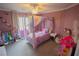 Whimsical bedroom with canopy bed, pastel decor, and playful accents at 10323 Hardy Falls St, Las Vegas, NV 89141