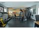 Well-equipped home gym featuring treadmills, weights, and rustic wood paneling at 10323 Hardy Falls St, Las Vegas, NV 89141