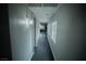 Hallway with dark floors and gray walls leading to other rooms in the house at 10323 Hardy Falls St, Las Vegas, NV 89141