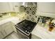 The kitchen boasts a new stainless steel range and oven set in modern marble countertops at 10323 Hardy Falls St, Las Vegas, NV 89141