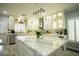 Bright kitchen features a large island with pendant lighting and modern cabinetry at 10323 Hardy Falls St, Las Vegas, NV 89141