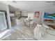 Open-concept living area with updated kitchen, dining space, modern fireplace and decorative stone accent wall at 10323 Hardy Falls St, Las Vegas, NV 89141