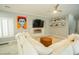 Bright living room featuring a modern fireplace and stone accent wall with bright decor, and plush neutral-toned sofas at 10323 Hardy Falls St, Las Vegas, NV 89141