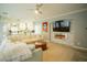 Bright living room with a modern fireplace, decorative stone accent wall, and an open view to the updated kitchen at 10323 Hardy Falls St, Las Vegas, NV 89141