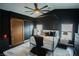 Modern bedroom with a canopy bed, accent wall, barn door and decorative ceiling fan at 10323 Hardy Falls St, Las Vegas, NV 89141