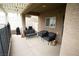 Relaxing covered patio with outdoor seating, privacy screen, and view of the backyard at 10323 Hardy Falls St, Las Vegas, NV 89141