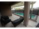 Covered patio featuring outdoor seating area and a view of the fenced pool and spa at 10323 Hardy Falls St, Las Vegas, NV 89141