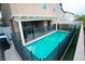 Backyard pool featuring a safety fence, covered patio, and artificial turf at 10323 Hardy Falls St, Las Vegas, NV 89141
