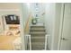 Bright staircase leading to the upper level, featuring modern decor and a baby gate at the bottom at 10323 Hardy Falls St, Las Vegas, NV 89141