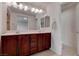 Bright bathroom features white fixtures, double sinks, and a large mirror at 10478 Beallsville St, Las Vegas, NV 89141