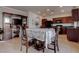Cozy dining area features wood floors, table with a floral tablecloth and views to the kitchen at 10478 Beallsville St, Las Vegas, NV 89141