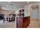 Open-concept floor plan with dining area, kitchen island and wood floors at 10478 Beallsville St, Las Vegas, NV 89141