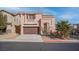 Charming two-story home with a landscaped front yard and attached two-car garage at 10478 Beallsville St, Las Vegas, NV 89141