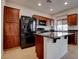 Modern kitchen with an island, stainless steel appliances, and wood flooring at 10478 Beallsville St, Las Vegas, NV 89141