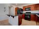Stylish kitchen with dark wood cabinets, granite countertops, and stainless steel appliances at 10478 Beallsville St, Las Vegas, NV 89141