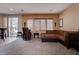 Comfortable living area featuring plush sofa, massage chair, and large windows at 10478 Beallsville St, Las Vegas, NV 89141