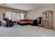 Spacious living room with carpeted floors, sectional sofa, and large windows at 10478 Beallsville St, Las Vegas, NV 89141