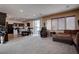 Open concept living area with carpet, dining table, and view of the kitchen at 10478 Beallsville St, Las Vegas, NV 89141
