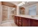 Beautifully renovated main bathroom with a double sink vanity and a tiled shower at 10478 Beallsville St, Las Vegas, NV 89141