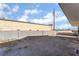 Large, partially graveled backyard enclosed by a block wall, offering potential for landscaping at 116 W Victory Rd, Henderson, NV 89015