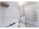 Bright bathroom with vanity, black fixtures, tiled floors, and shower over tub at 116 W Victory Rd, Henderson, NV 89015