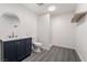 Modern bathroom with navy vanity, round mirror, floating shelf, and walk-in shower stall at 116 W Victory Rd, Henderson, NV 89015