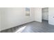 Bright bedroom features fresh gray flooring, a window, and a closet for ample storage space at 116 W Victory Rd, Henderson, NV 89015