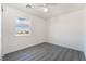 This light-filled bedroom features a modern ceiling fan, gray wood-look flooring and one window at 116 W Victory Rd, Henderson, NV 89015