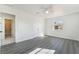 Bright bedroom with gray laminate floors, white walls, a window, and a door leading to the bathroom at 116 W Victory Rd, Henderson, NV 89015