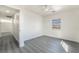 Bright bedroom featuring a window and stylish gray wood-look flooring at 116 W Victory Rd, Henderson, NV 89015