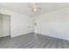 Bright bedroom with modern ceiling fan, closet, and stylish gray wood-look flooring at 116 W Victory Rd, Henderson, NV 89015
