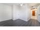 Spacious bedroom featuring a ceiling fan, neutral walls, gray laminate floors, and an open door at 116 W Victory Rd, Henderson, NV 89015