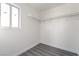This closet features gray flooring, a window, shelving, and plenty of hanging storage space at 116 W Victory Rd, Henderson, NV 89015
