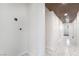 Bright hallway featuring a wooden slat ceiling, marble floors, and white walls at 116 W Victory Rd, Henderson, NV 89015