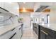 Modern kitchen featuring white cabinets, marble countertops, stainless steel appliances, and a contrasting island at 116 W Victory Rd, Henderson, NV 89015