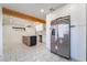 Modern kitchen with stainless appliances, island, and marble-style tile flooring at 116 W Victory Rd, Henderson, NV 89015
