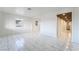Bright, spacious living room features white walls and marble-style tile flooring at 116 W Victory Rd, Henderson, NV 89015