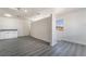 Open floorplan area with gray wood-look flooring, a separation wall, and a countertop with cabinets at 116 W Victory Rd, Henderson, NV 89015