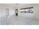 Bright, spacious living room features white walls and marble-style tile flooring at 116 W Victory Rd, Henderson, NV 89015