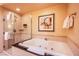 Relaxing bathroom featuring large soaking tub and separate glass-enclosed shower with elegant fixtures at 125 E Harmon Ave # 2801&2803, Las Vegas, NV 89109
