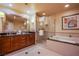 Bathroom with double sink vanity, soaking tub, and glass enclosed shower at 125 E Harmon Ave # 2801&2803, Las Vegas, NV 89109