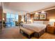 Hotel bedroom features a king-size bed, sitting area, and city views at 125 E Harmon Ave # 2801&2803, Las Vegas, NV 89109