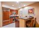 Compact kitchen boasts wood cabinets, modern appliances, granite counters, and cozy breakfast bar seating at 125 E Harmon Ave # 2801&2803, Las Vegas, NV 89109