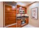 Elegant kitchen featuring stainless steel appliances, sleek granite countertops, and stylish cherry wood cabinetry at 125 E Harmon Ave # 2801&2803, Las Vegas, NV 89109