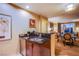 Convenient kitchenette with stainless appliances and granite counters opens to the living room at 125 E Harmon Ave # 2801&2803, Las Vegas, NV 89109