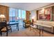 Hotel living room area with city views, seating, and dining table at 125 E Harmon Ave # 2801&2803, Las Vegas, NV 89109
