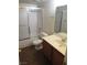Well-lit bathroom with a shower-tub combo, and wooden vanity at 1341 Cinder Rock Dr # 101, Las Vegas, NV 89128