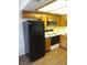 Kitchen showing appliances and wood cabinets offers a practical space for meal preparation at 1341 Cinder Rock Dr # 101, Las Vegas, NV 89128